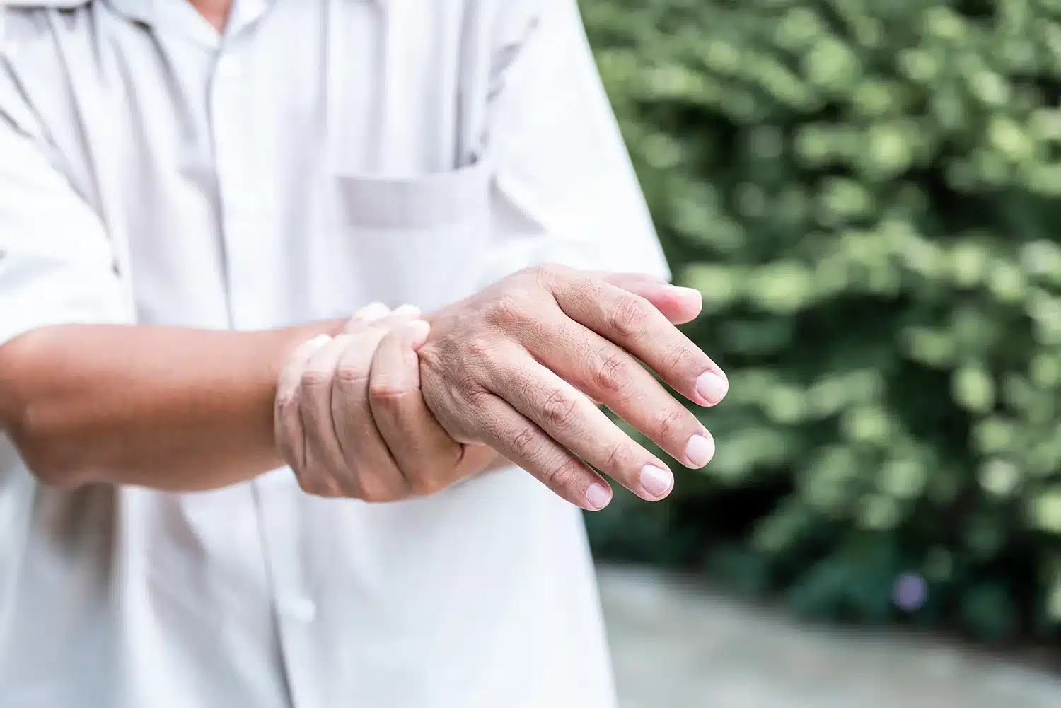 An older adult holds their wrist, a bone that can break more easily as bone density decreases with age An older adult holds their wrist, a bone that can break more easily as bone density decreases with age