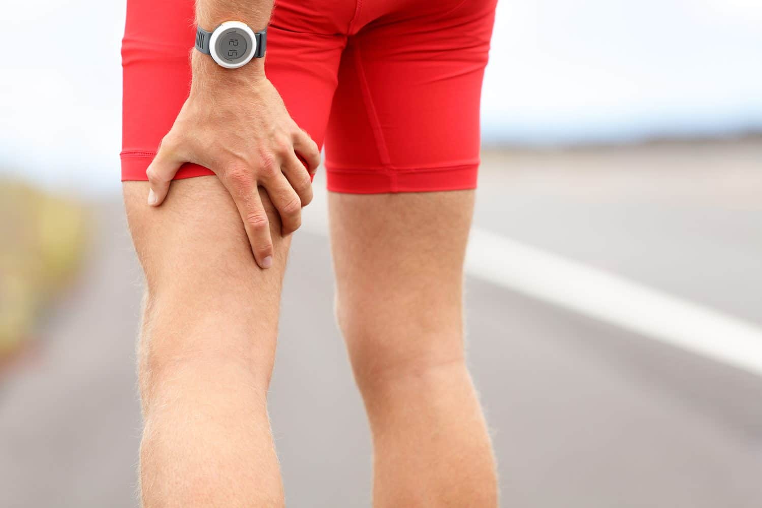 Runner holding back of thigh leg pain Runner holding back of thigh leg pain